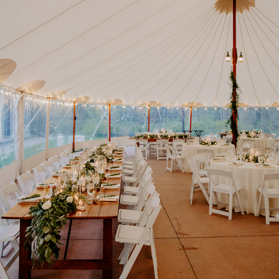 Tented outdoor wedding with garland and farm tables at Willowdale Estate just outside Boston, MA