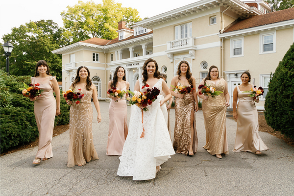 Bride and bridesmaids with champagne bridal attire at Tupper Manor in Beverly, MA 
