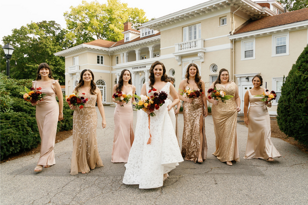 Bride and bridesmaids with champagne bridal attire at Tupper Manor in Beverly, MA