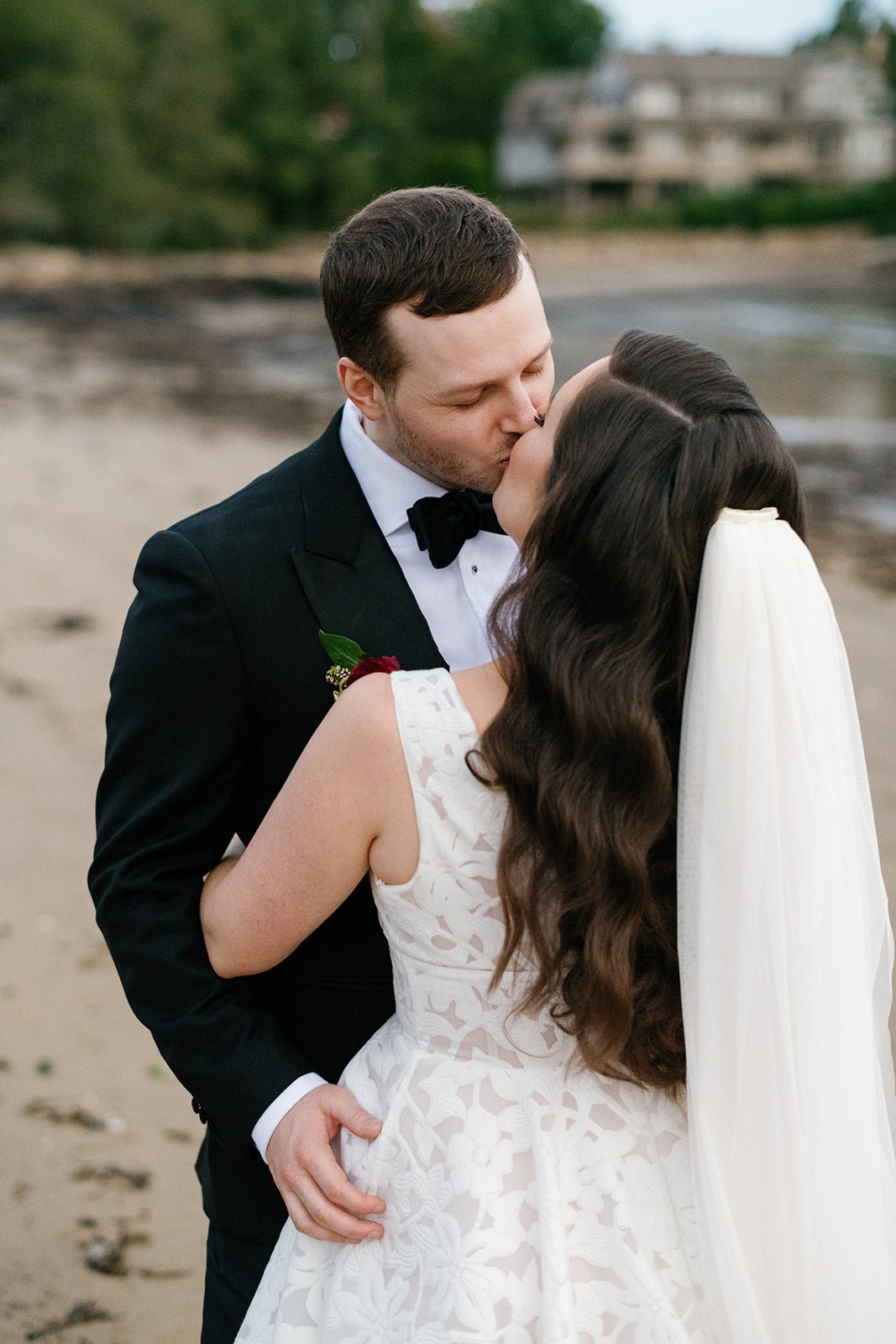 Bride and groom kissing outside Tupper Manor Mansion