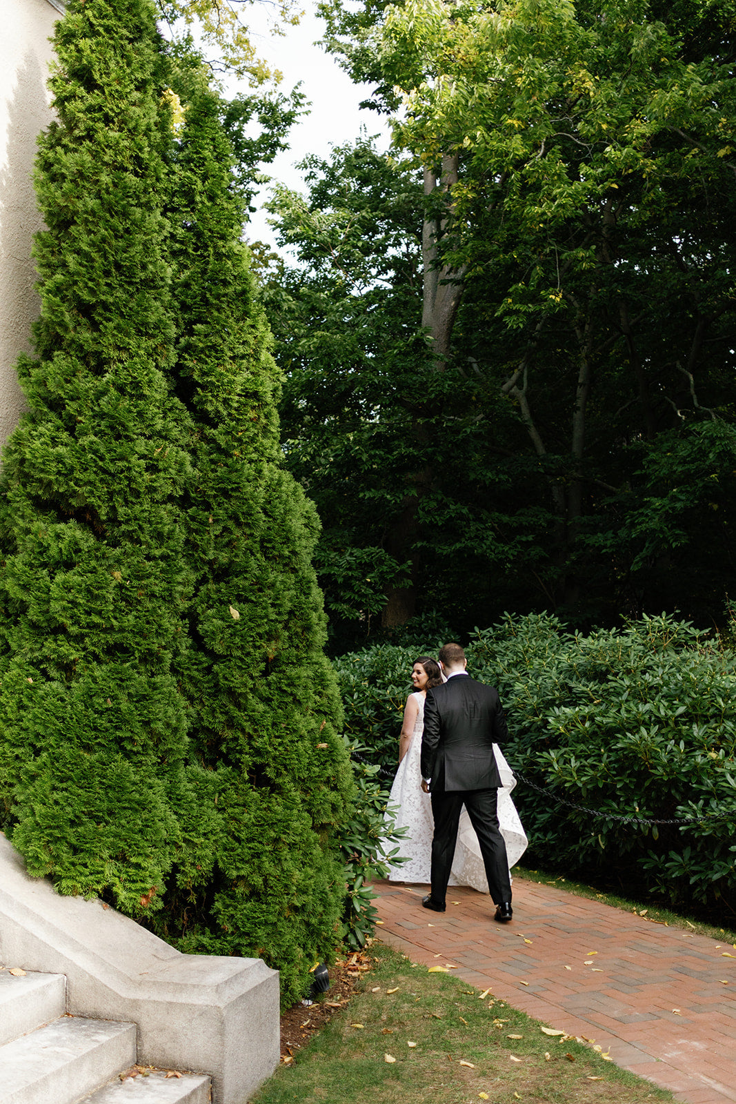 Gardens at Tupper Manor wedding venue North Shore Boston, MA. Bride and groom walking.