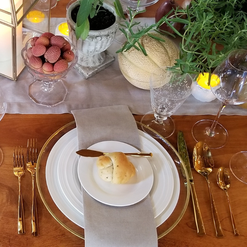 Gold flatware set at table with fruit and plant tablescape Massachusetts, MA New England
