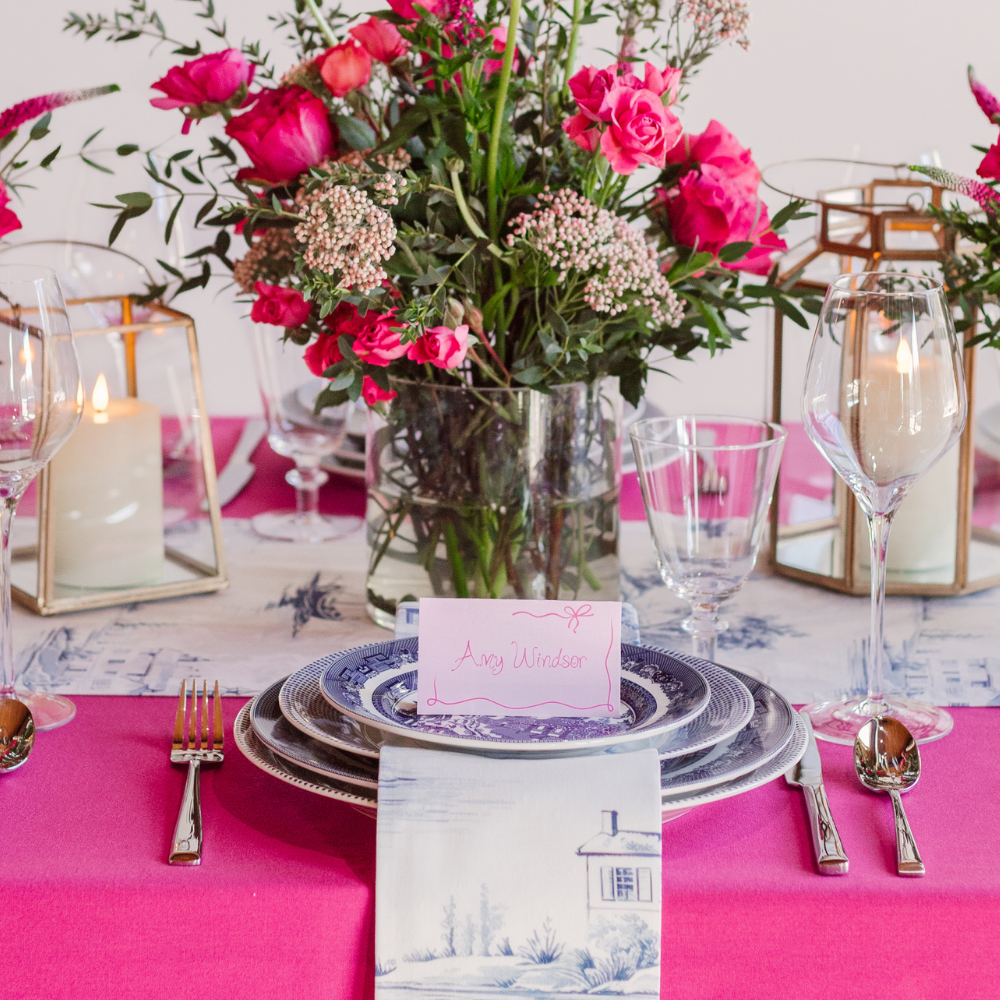Tablescape in Crystal Ballroom with blue, pink and white tablescape and atterned dishware for place setting rental.