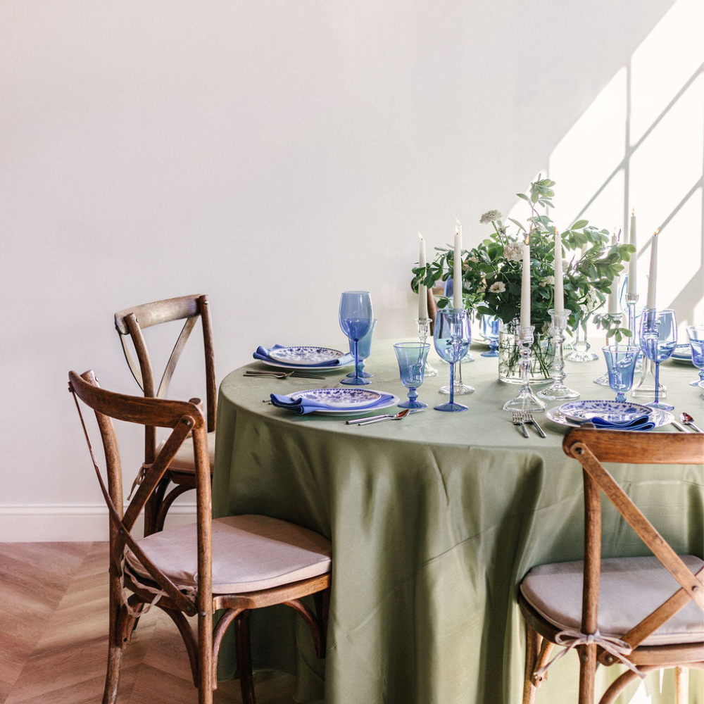 A secret garden party with sage linen and blue accented dinnerware, blue glassware hemstitch linen napkins in the Greater Boston area.
