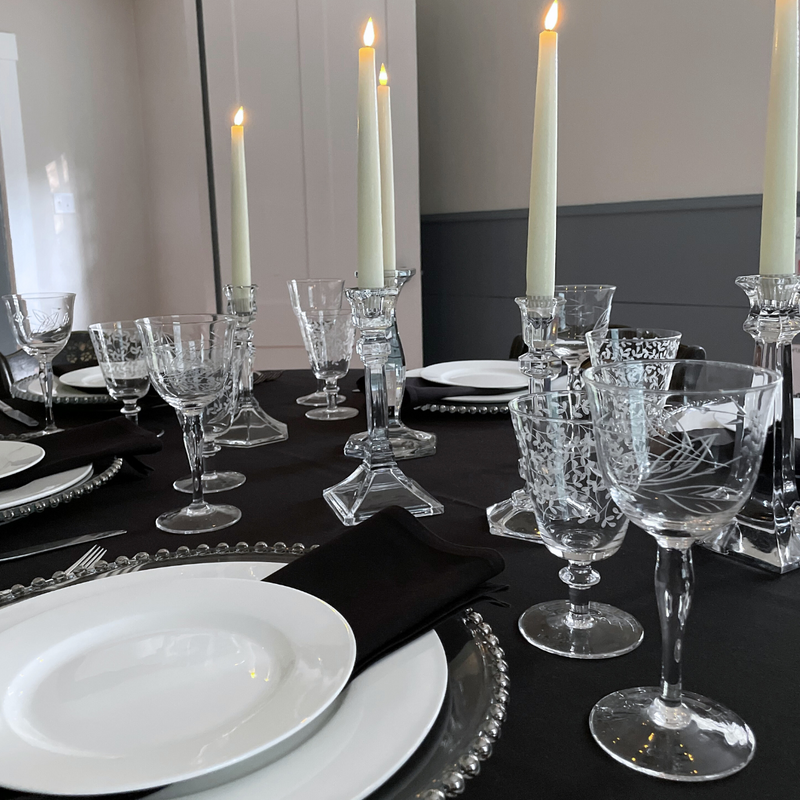 Black and white tabletop set for a party with silver beaded charger at place setting in Boston, Massachusetts
