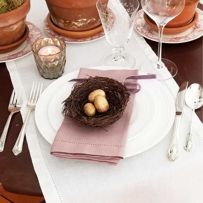 Spring tablescape with bird's nest and vintage silverplate flatware Massachusetts rentals