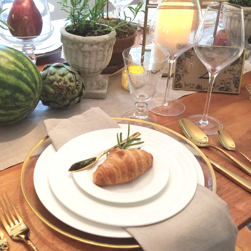 Tablescape with white rimmed dinnerware and gold rimmed chargers with croissant Springfield, Massachusetts, New England